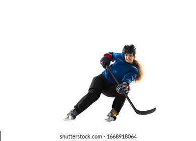 Young female hockey player with the stick on ice court and white background. Sportswoman wearing equipment and helmet training. Concept of sport, healthy lifestyle, motion, action, human emotions. - Powered by Shutterstock