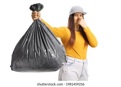 Young Female Holding A Smelly Bin Bag Isolated On White Background