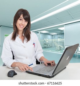 Young Female Hospital Administrative In A Desk At The Hospital Hall