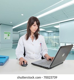 Young Female Hospital Administrative In A Desk At The Hospital Hall