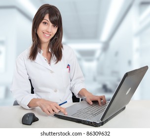 Young Female Hospital Administrative In A Desk At The Hospital Hall