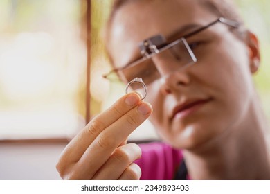 Young female jeweler making jewelry in workshop - Powered by Shutterstock