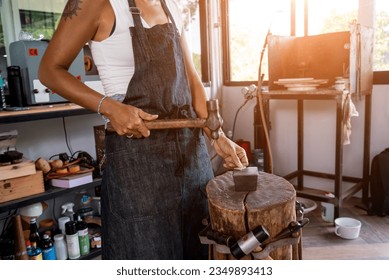 Young female jeweler making jewelry in workshop - Powered by Shutterstock