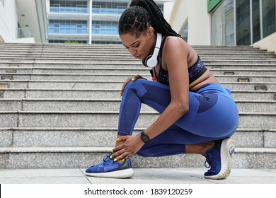 Young female jogger touching ankle that hurts after run, sport injury concept - Powered by Shutterstock