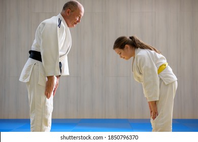 Young female judo girl showing respect to old judo teacher - Shutterstock ID 1850796370