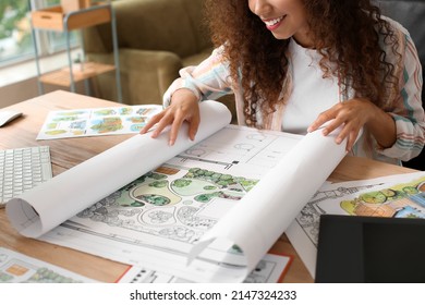 Young female landscape designer working in office - Powered by Shutterstock