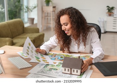 Young Female Landscape Designer Working In Office