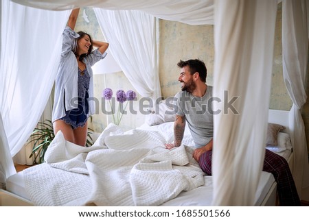 Similar – Image, Stock Photo Man showing baby clothes to pregnant woman