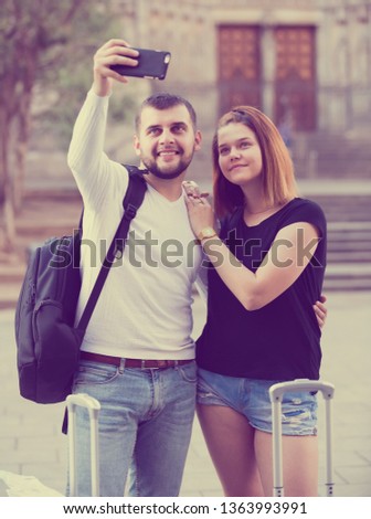 Similar – couple taking selfie in the street