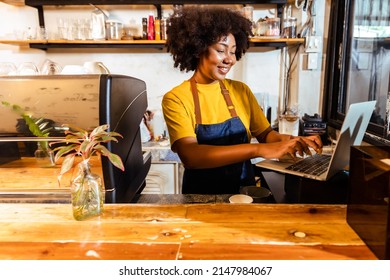 Young Female manager in restaurant with digital tablet or notebook.Close up of joyful African American young woman worker in apron stands in cafe restaurant.Small business concept. - Powered by Shutterstock