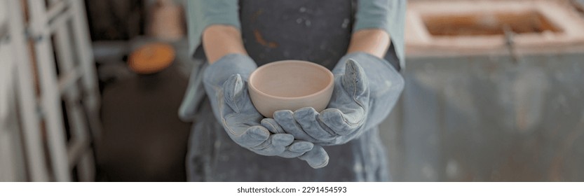 Young female master working with pottery in workroom - Powered by Shutterstock