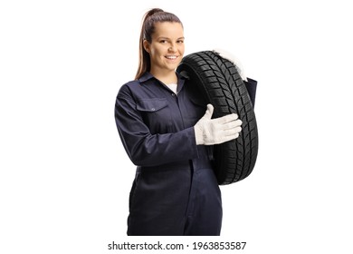 Young female mechanic worker carrying a car tire isolated on white background - Powered by Shutterstock