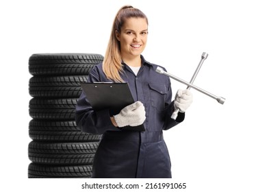 Young female mechanic worker holding a plug wrench and a clipboard isolated on white background - Powered by Shutterstock