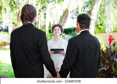 Young female minister uses a tablet PC to perform a gay marriage ceremony.   - Powered by Shutterstock