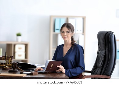 Young Female Notary Working In Office