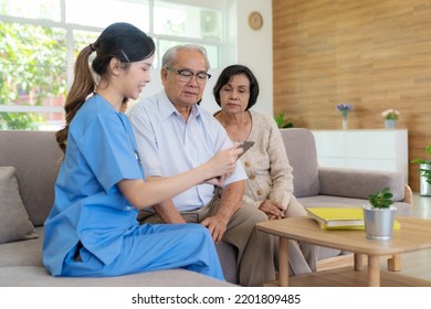 Young Female Nurse Doctor Caregiver Holding Tablet Explaining Prescription Prescribing Drug To Elderly Patient At Nursing Home. Record Check Up Information. Healthcare Pharmacy And Insurance Service