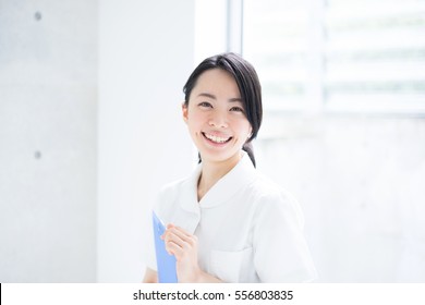 Young female nurse holding file in a hospital - Powered by Shutterstock