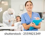 Young female nurse taking notes during examination of patient in dental office