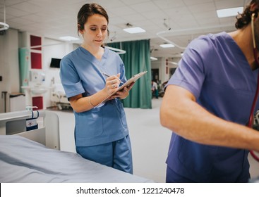 Young Female Nurse Taking Notes