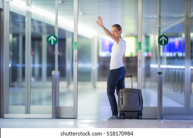 Young Female Passenger At The Airport, Saying Goodbye To Her Family, Friends, Going To Board Her Flight On Time (color Toned Image; Shallow DOF) 