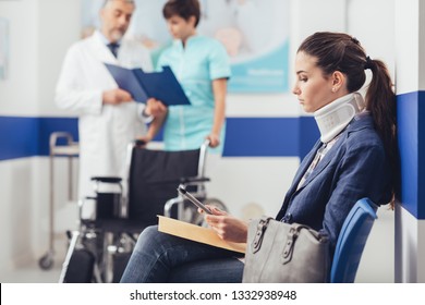 Young female patient with cervical collar support at the hospital, she is sitting in the waiting room and connecting with a digital tablet, medical staff working on the background - Powered by Shutterstock