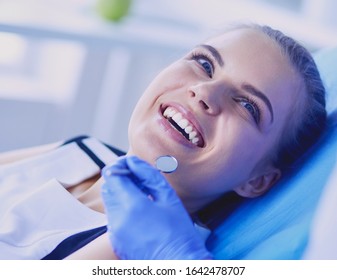 Young Female Patient With Pretty Smile Examining Dental Inspection At Dentist Office.