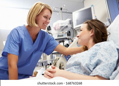 Young Female Patient Talking To Nurse In Emergency Room