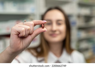 A Young Female Pharmacist Reads Medicine Instructions While Standing In The Chemist's Aisle. Pharmacy. Pharmacist. Medicine. Tablets