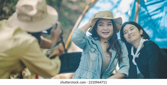 Young Female Photographer Enjoy To Take Photo Her Friends, She Use Digital Camera And Lovely Girl Pose At Camping Tent In Nature Forest, Copy Space