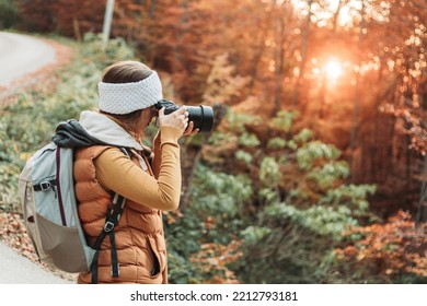 Young Female Photographer Taking Photos In The Nature With Her Camera