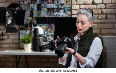 Young Female Photographer Working In Studio.
