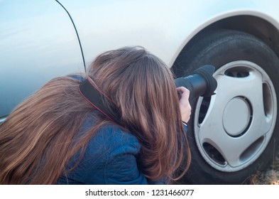 Young Female Photojournalist Taking A Shot