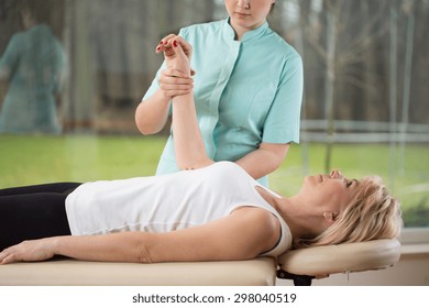 Young Female Physiotherapist With Patient During Rehabilitation