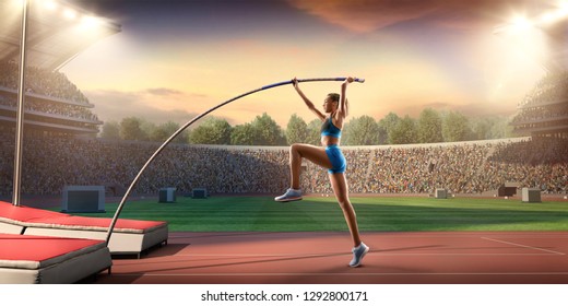 Young Female Pole Vault Athlete With Pole Bar. Women In Sport Clothes At Athletic Sport Track In Professional Stadium