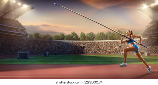 Young Female Pole Vault Athlete With Pole Bar. Women In Sport Clothes At Athletic Sport Track In Professional Stadium