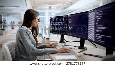 Young Female Programmer Typing Code While Monitoring Cloud System Alerts.