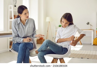 Young Female Psychologist Talk With Girl Teenager Suffering From Bullying In School Feeling Depressed. Caring Woman Social Worker Have Meeting With Teen Schoolgirl Depression Or Adolescence Crisis.