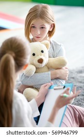 Young Female Psychologist Working With Teenager Girl In Office