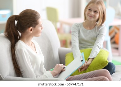 Young Female Psychologist Working With Teenager Girl In Office