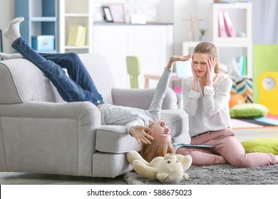 Young Female Psychologist Working With Teenager Girl In Office