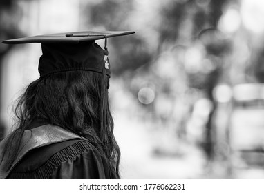 Young female recent graduate heads out on the sidewalk, looking for employment - Shutterstock ID 1776062231