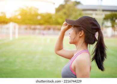 Young Female Relaxing After After Workout And Jogging At The Football Stadium With Sunbeam. She Have A Beautiful Smile.