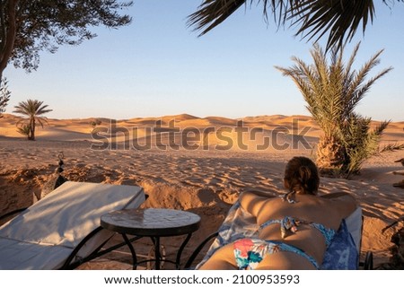 A young female relaxing in the desert
