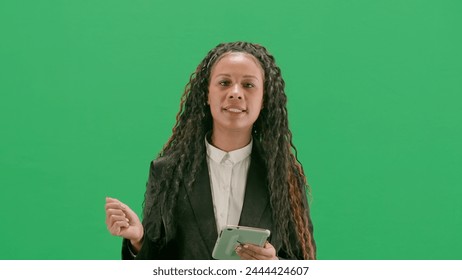 Young female reporter isolated on chroma key green screen background. African american woman tv news host walking holding tablet and talking. - Powered by Shutterstock