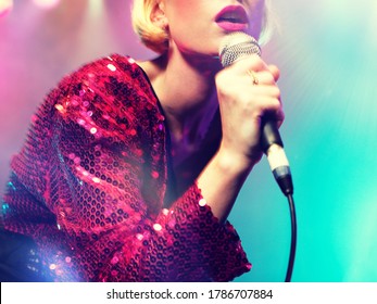 Young female rockstar Singing in Concert - Powered by Shutterstock