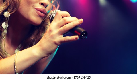 Young Female Rockstar Singing In Concert