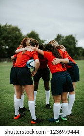 Young Female Rugby Players Huddling