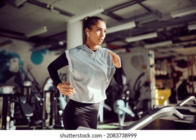 Young female runner exercising on treadmill in a gym. - Powered by Shutterstock