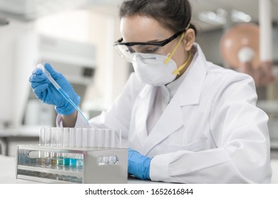 Young Female Scientist Working In The CDC Laboratory.