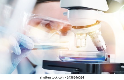 Young Female Scientist Working With Microscope